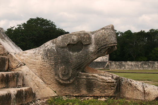 Feathered serpent head at the bottom of the stairs of El Castillo