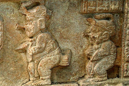 Two dwarfs on a ball court panel underneath building 33